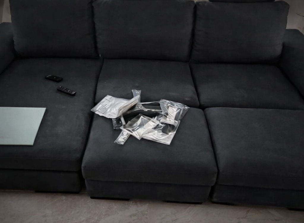 Black sofa before upholstery cleaning in Limassol
